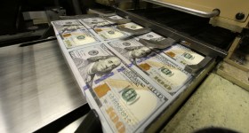 Dollar bills on the printing press