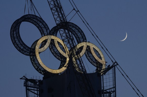Olympic sign hoisted into place by a crane