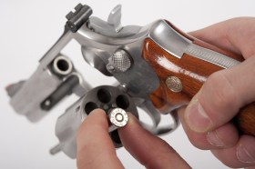 Revolver being loaded with bullets