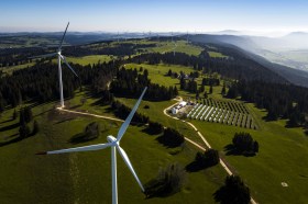 Aerial view of windmills and solar panels