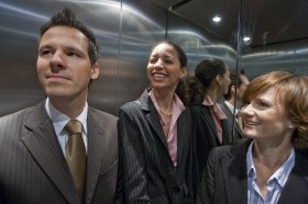 Two women and a man in a lift