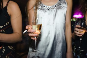 Girl holding wine glass and cigarette