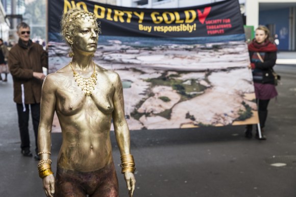 Activist in gold demonstrates against dirty gold at Baselworld 2016