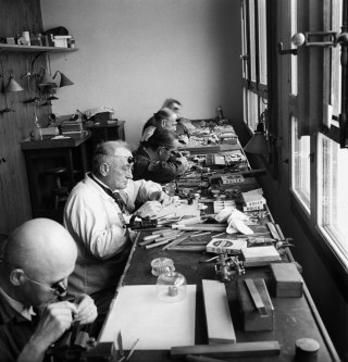 Watchmakers work at a Rolex manufacturer in Geneva, Switzerland, on November 7, 1940.