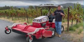 Man with agricultural machinery in a vineyard