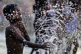 Sri Lankan boy plays in water fountain
