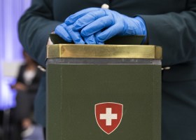 Parliamentary ballot box, person wearing blue gloves