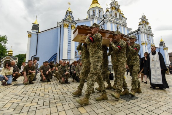 Ukraine soldiers carry coffin.