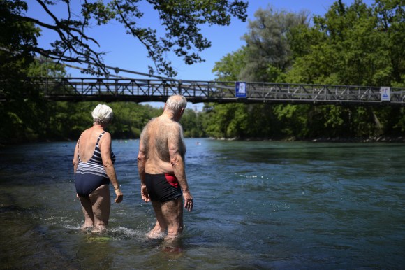 Two people ready for a swim in a river