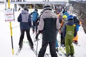 Skiers queue up at a ski lift in Switzerland
