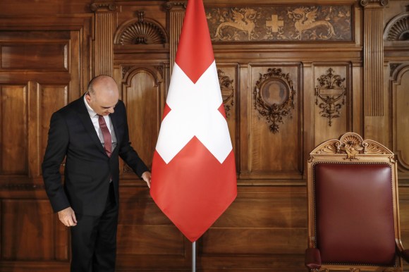 berset standing next to Swiss flag