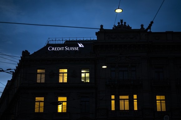 A Credit Suisse building illuminated at night