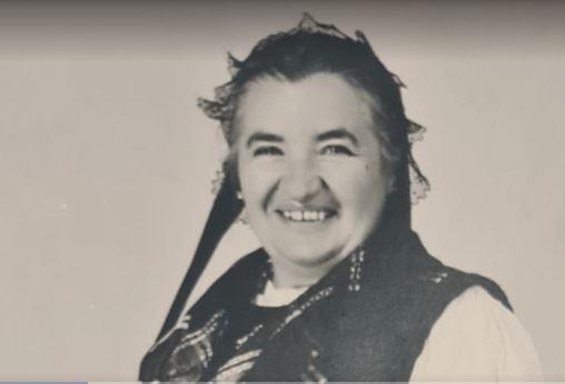 Old photo of a woman in traditional costume