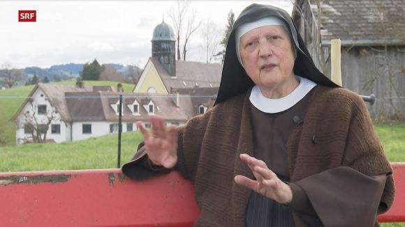 The nun with the convent behind her