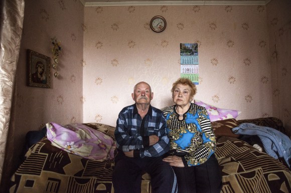 Ukrainian couple waiting on a bed