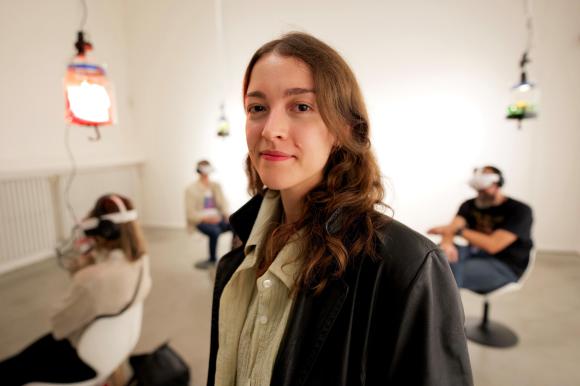 Zoe Roellin in a room with people attached to VR headsets