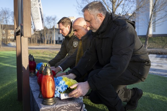 Swiss President Alain Berset (centre) paying tribute to victims in Bucha, Ukraine