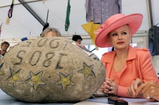 حجارة أونسبونن وبجوارها امرأة ترتدي قبعة